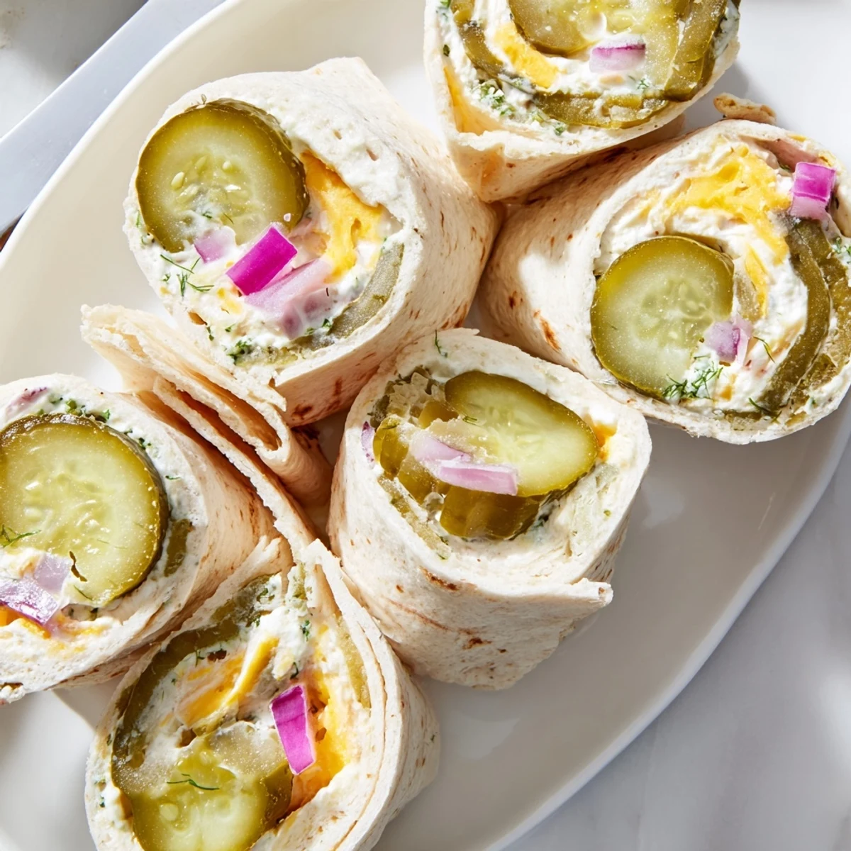 Crispy, tangy Pickle-in-a-Blanket snack wrapped in soft tortilla, perfect for parties.  