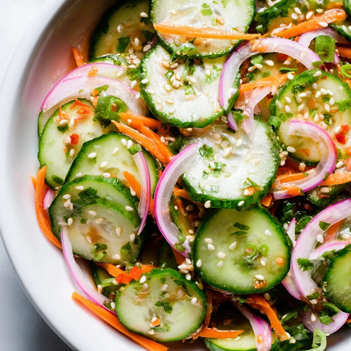 Refreshing cucumber salad remix tossed in tangy dressing, perfect for summer picnics.  
