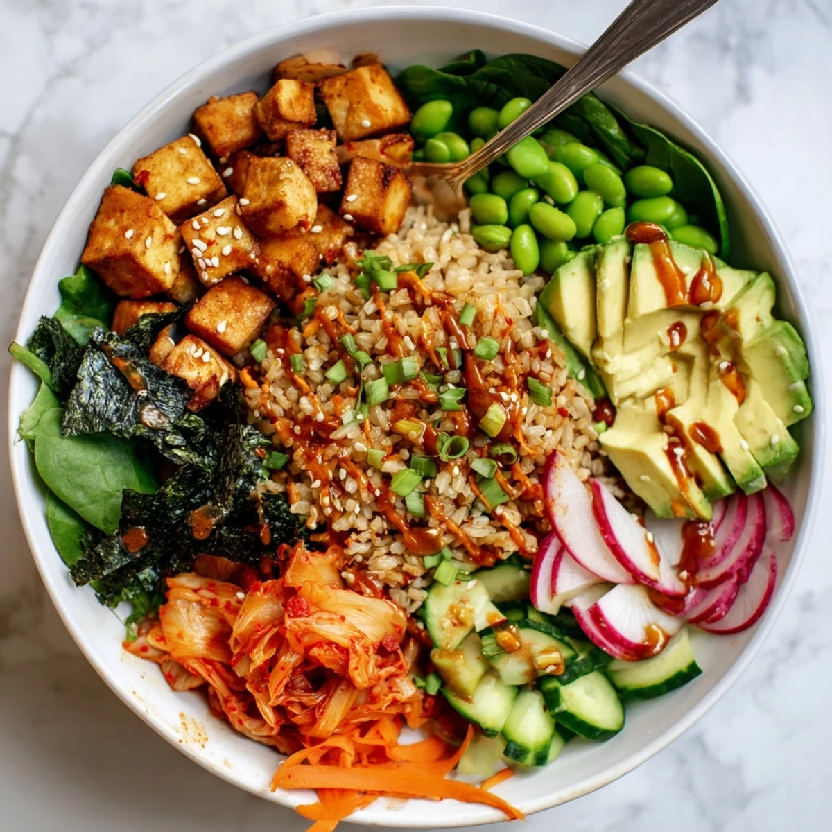 Vibrant fermented vegetable bowl topped with kimchi, fresh greens, and avocado slices.  