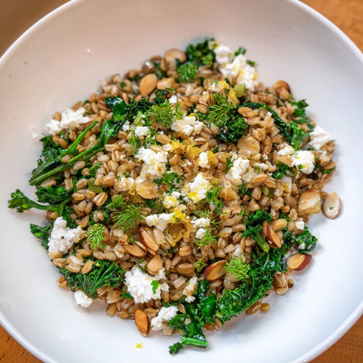 Delicious warm farro & greens pilaf; golden almonds and fresh parsley brighten this flavorful dish.
