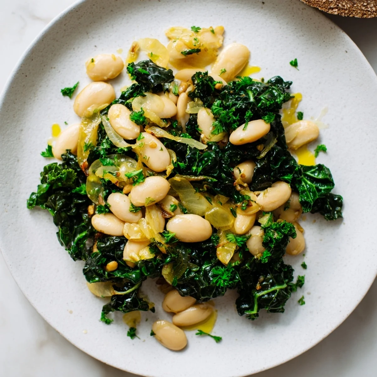 Fragrant steam rising from a bowl of Garlicky Beans with Winter Greens, ready to serve and enjoy.
