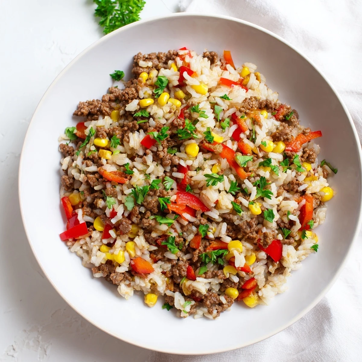 Warm Ground Beef Skillet with tender rice and vibrant vegetables, ready for a delicious dinner.