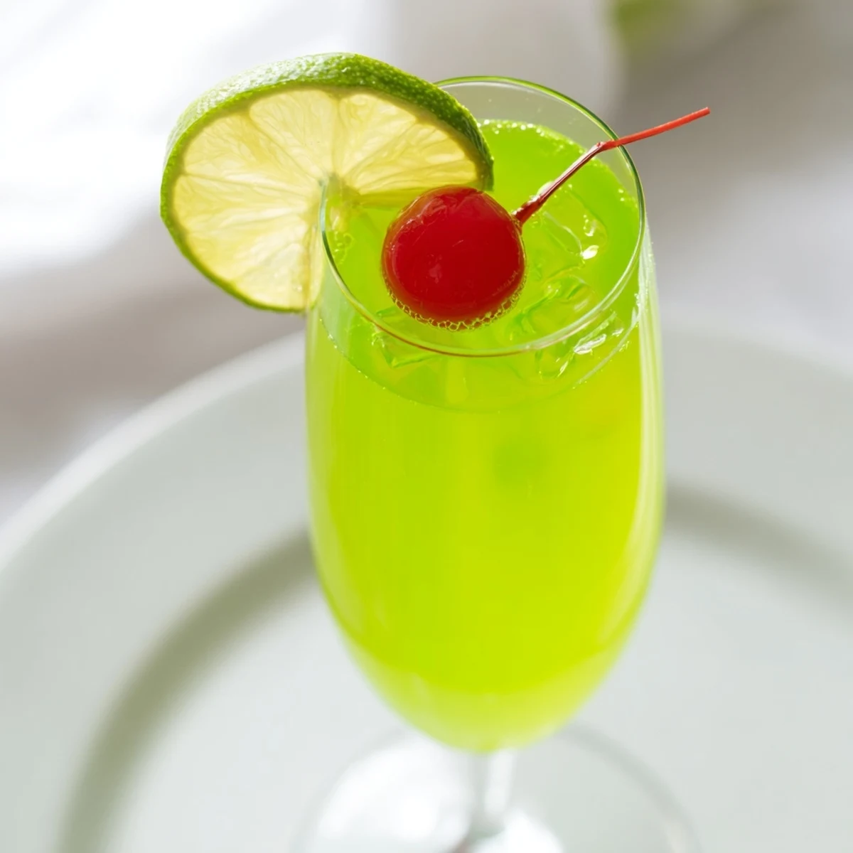 Sweet and bubbly Quick Grinch Mimosa Mocktail, a festive, non-alcoholic holiday drink creation.