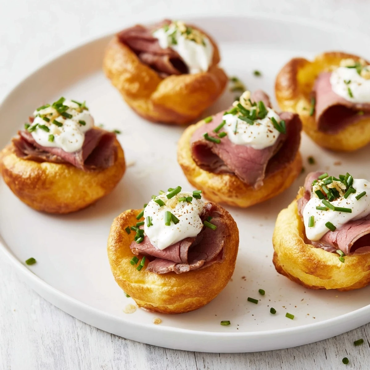 Golden brown Express Holiday Yorkshire Pudding Bites bursting with flavorful roast beef and creamy horseradish filling.