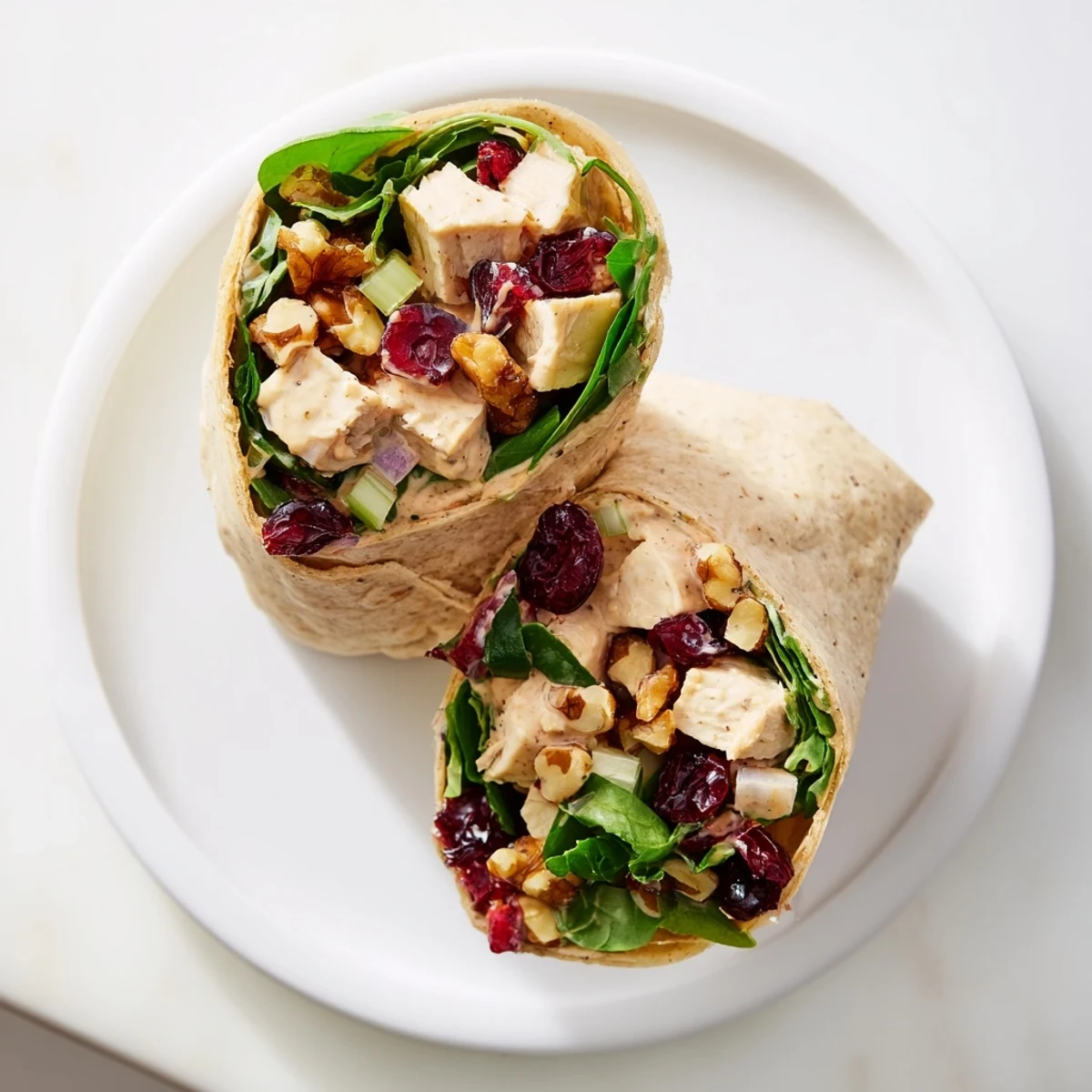 Festive Cranberry Pecan Chicken Salad Christmas Wrap, overflowing with juicy chicken and crunchy pecans.