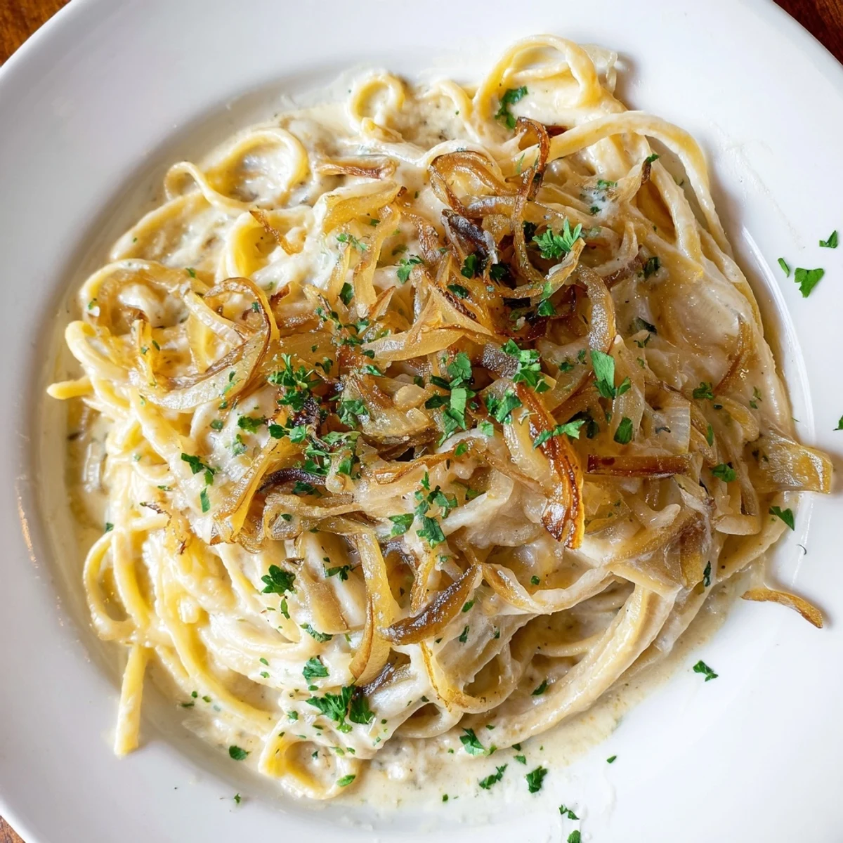 Close-up on the savory One-Pot French Onion Pasta, showing the rich broth and soft, tender pasta.
