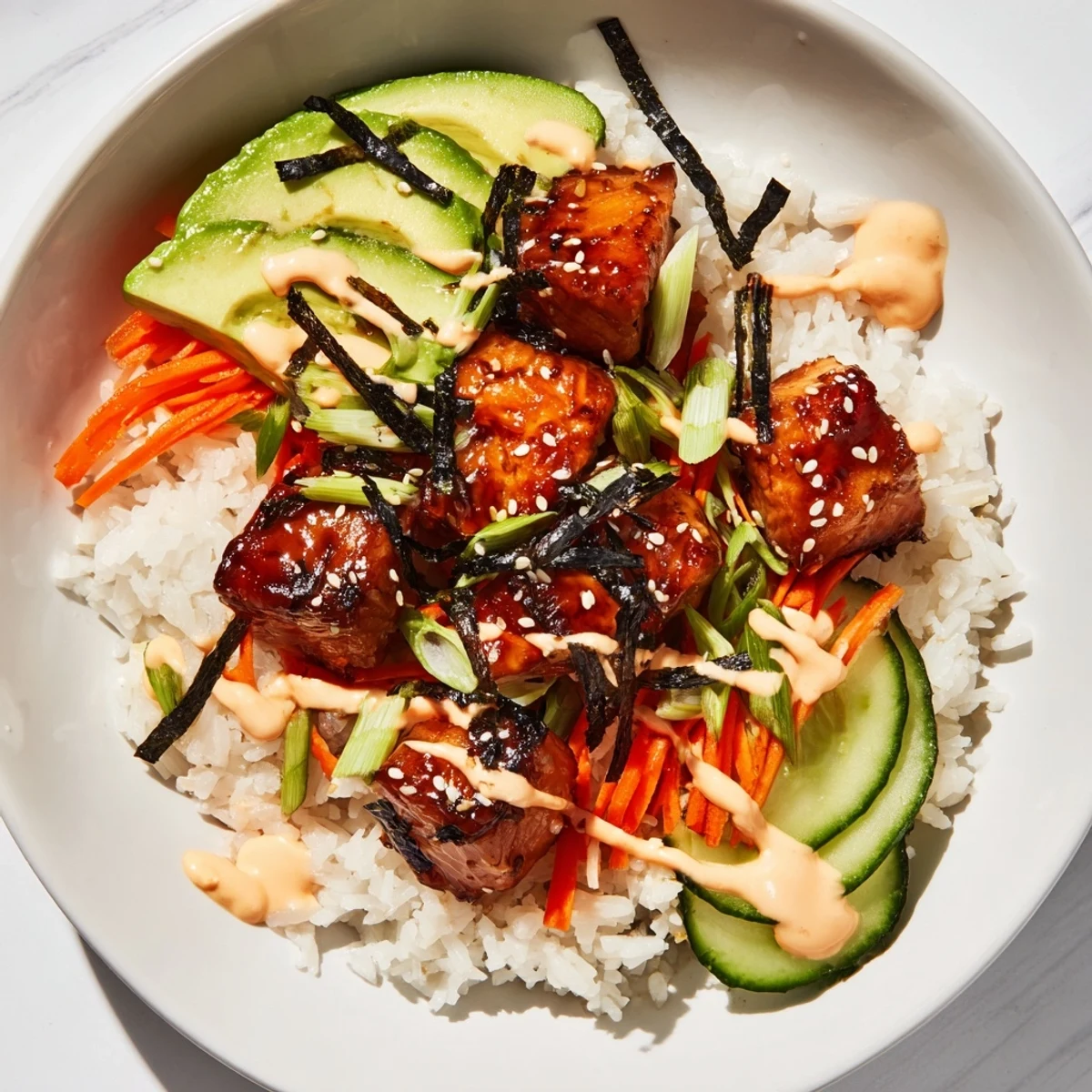 A close-up of a delicious teriyaki salmon rice bowl, showcasing glazed salmon and fluffy rice.