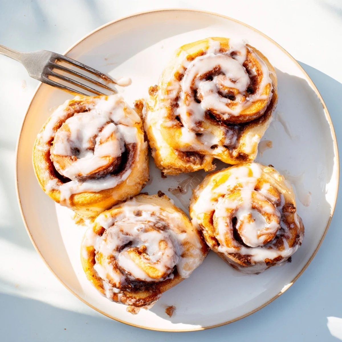 Freshly baked Pillow Soft Cinnamon Rolls topped with creamy glaze, ready for breakfast or brunch.
