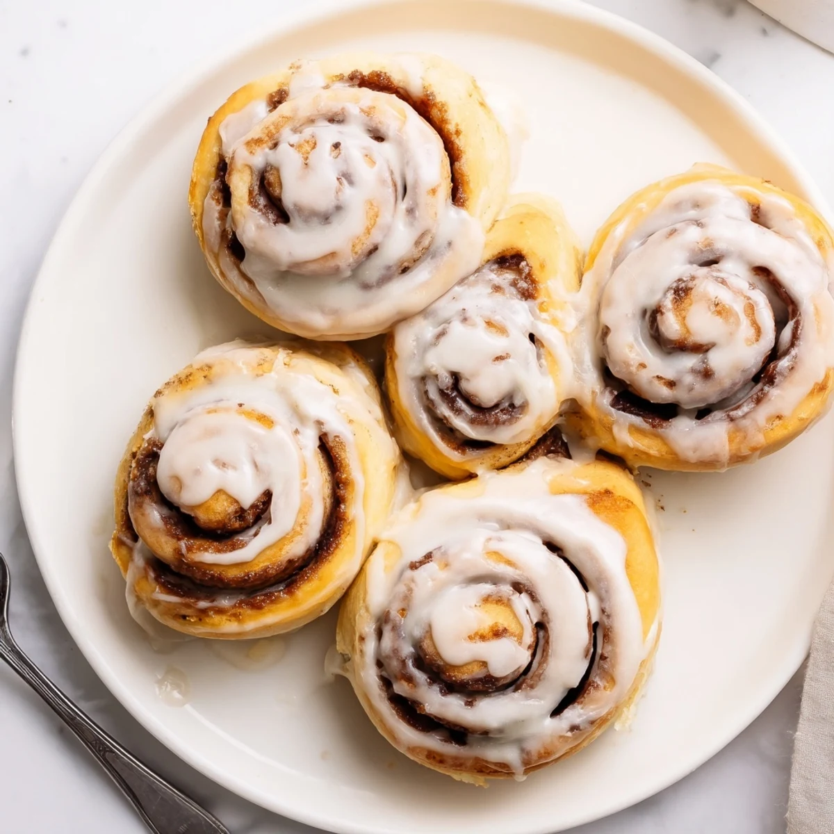 Warm Pillow Soft Cinnamon Rolls with buttery cinnamon swirls and rich cream cheese frosting.