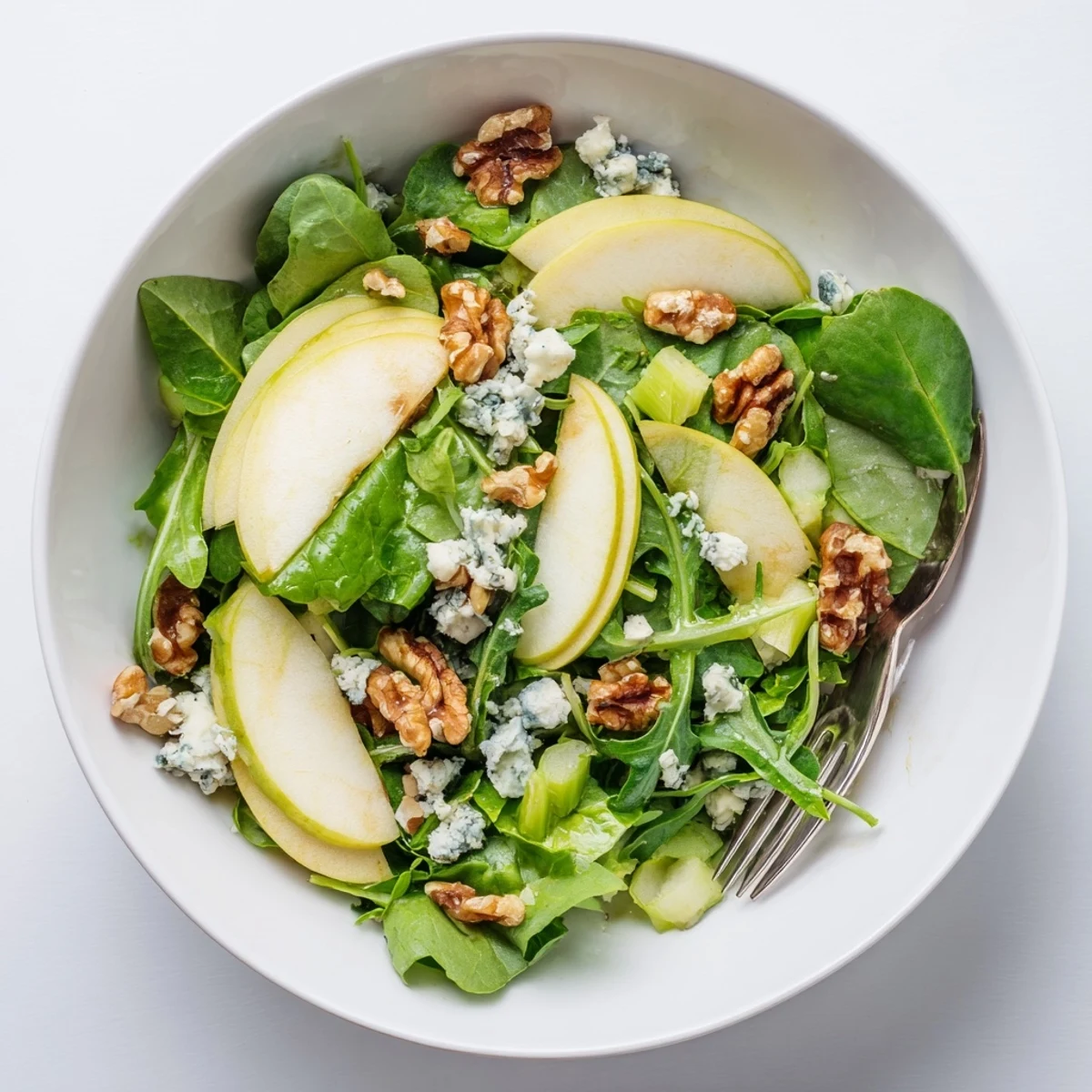 Crisp Honeycrisp apple slices tossed with crunchy walnuts and peppery arugula in a tangy apple cider vinaigrette.