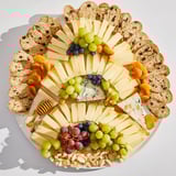 Magnificent Art Deco Arch Cheese Platter: an elegant, tiered arrangement with grapes, almonds, and honey.