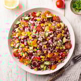 Hearty Dense Bean Salad with chickpeas, juicy tomatoes, and a sprinkle of nourishing hemp seeds.