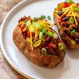 Close-up of a loaded Chili-Style Baked Potatoes, offering enticing textures and inviting aromas from the spices.