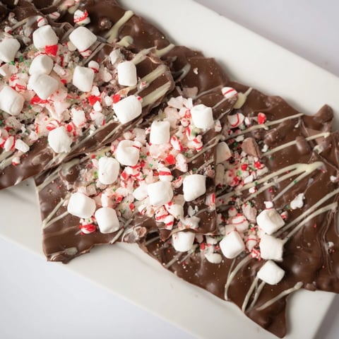 Semi-sweet chocolate base of the Viral Hot Chocolate Bomb Bark, speckled with cocoa mix and marshmallow topping.