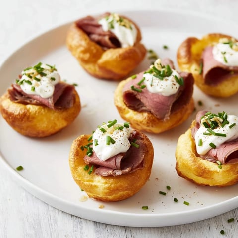 Golden brown Express Holiday Yorkshire Pudding Bites bursting with flavorful roast beef and creamy horseradish filling.