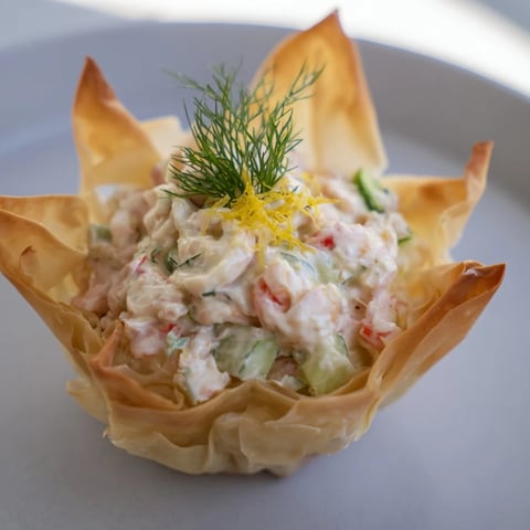 Golden, flaky Mini Star Cocktail Cups filled with savory shrimp salad, a perfect bite.