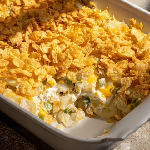 Baked Midwest Classic Funeral Potatoes with Pickle Ranch Twist: Creamy interior, crispy cornflake topping.