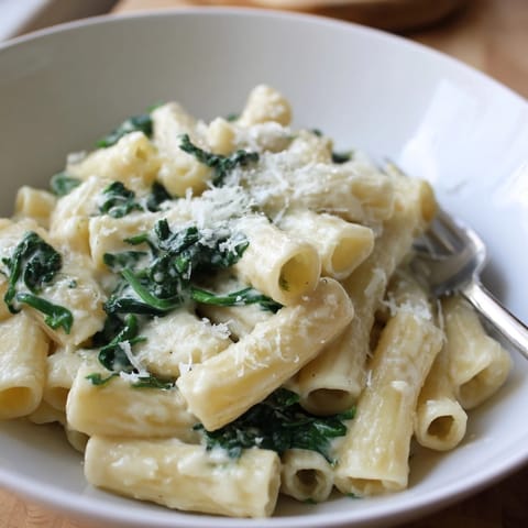 Creamy Spinach Alfredo Pasta recipe; easy dinner with vibrant green spinach leaves visible.