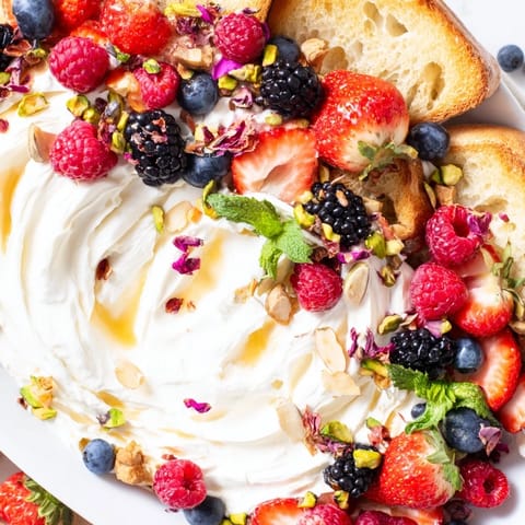 Whipped cream cheese Butter Board Dessert served with toasted baguette slices for sharing.  