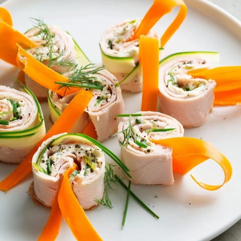 Freshly prepared Ribbon Dancer appetizer: vibrant veggie spirals and tasty turkey ready to eat.