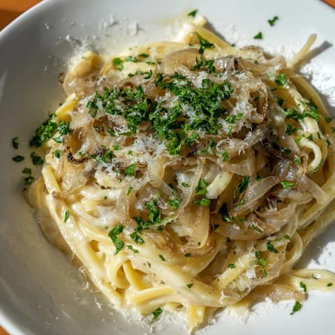 Melting Gruyère cheese blankets the creamy One-Pot French Onion Pasta, a hearty main course.