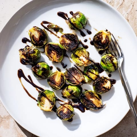 Roasted Brussels sprouts with balsamic reduction, served warm with caramelized edges and a tangy finish.