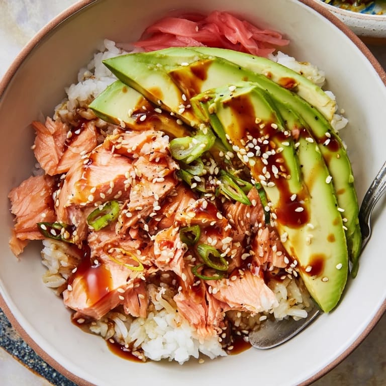 Flavorful salmon and rice bowl, enriched with fresh toppings for a delightful dish.