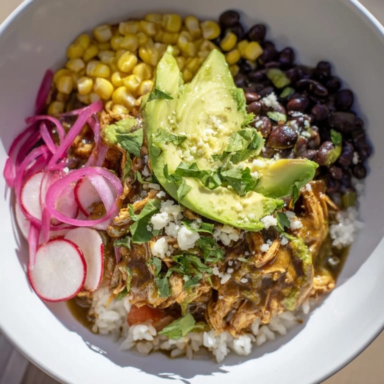A close-up of a flavorful Green Enchiladas Rice Bowl, showcasing rice, chicken, and fresh cilantro garnish.