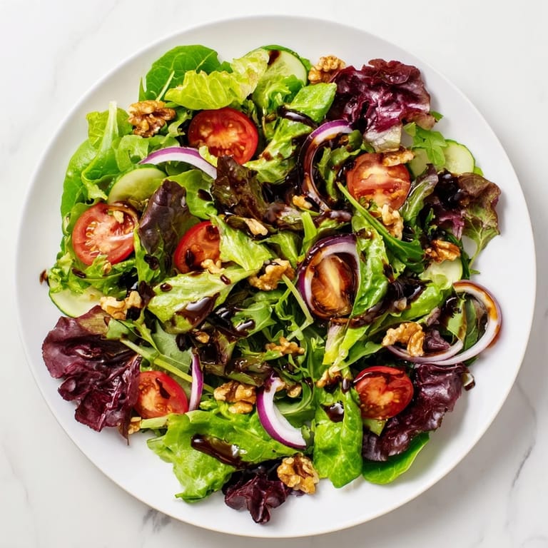 A bright, colorful photo of the Quick Balsamic Vinegar Salad served with toasted walnuts and fresh greens.