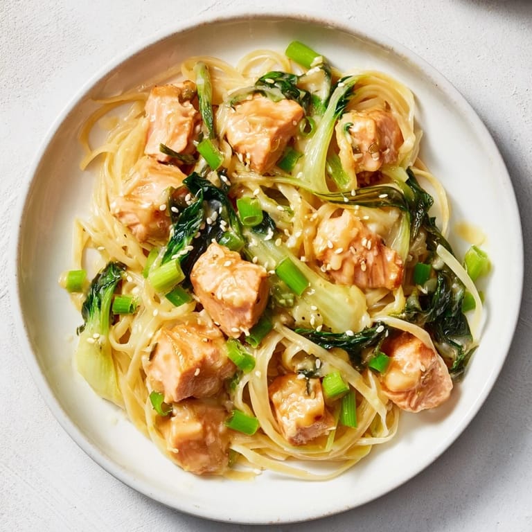 Savory Miso Butter Salmon Pasta: a comforting fusion meal garnished with fresh scallions and sesame seeds.