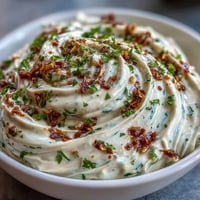 Creamy homemade chipotle lime mayonnaise with smoky peppers and fresh citrus zest in a glass bowl.